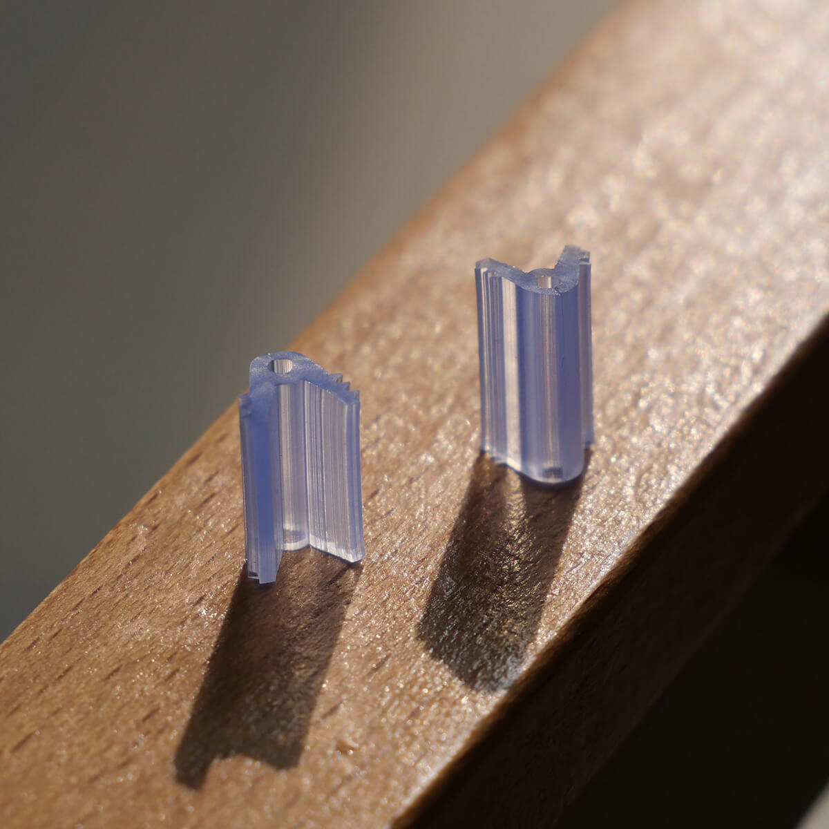 Close-up of transparent 1.4mm silicone grafting clips showing high light transmission for graft union observation