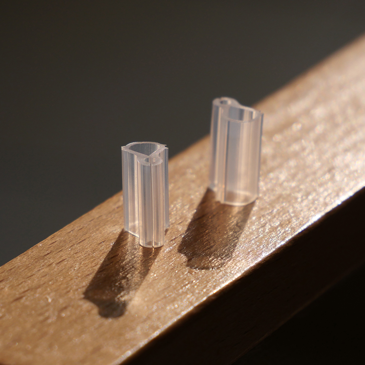 Close-up of transparent 1.5mm silicone grafting clips showing high light transmission for graft union observation